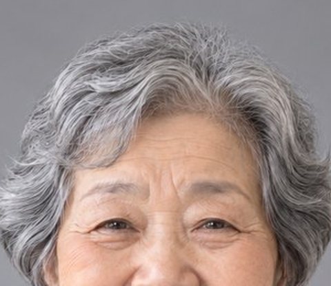女性の遺影の見本の、髪のまわりを大きくしたもの。背景は無地のグレー